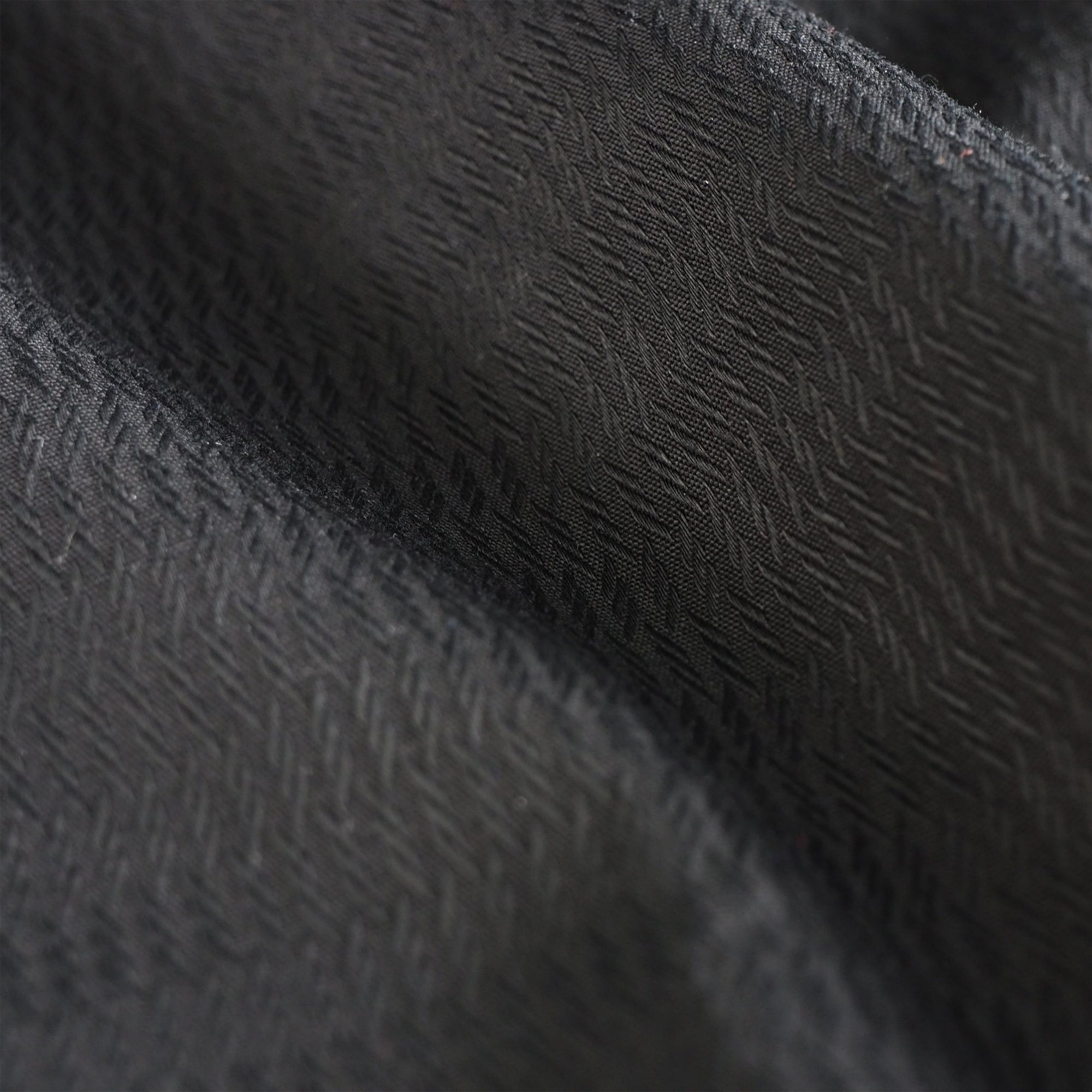 Close-up of black fabric from Adidas taekwondo uniform.