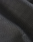 Close-up of black fabric from Adidas taekwondo uniform.