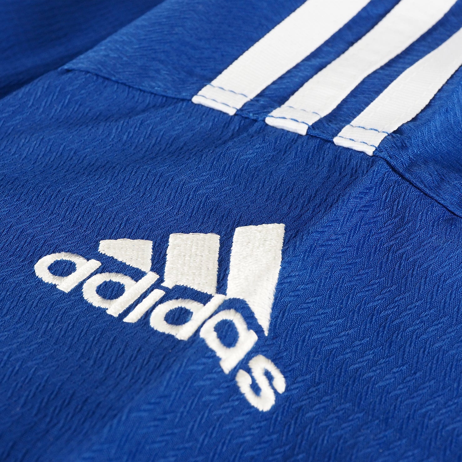 Close up of blue shirt from Adidas Champion Taekwondo uniform.