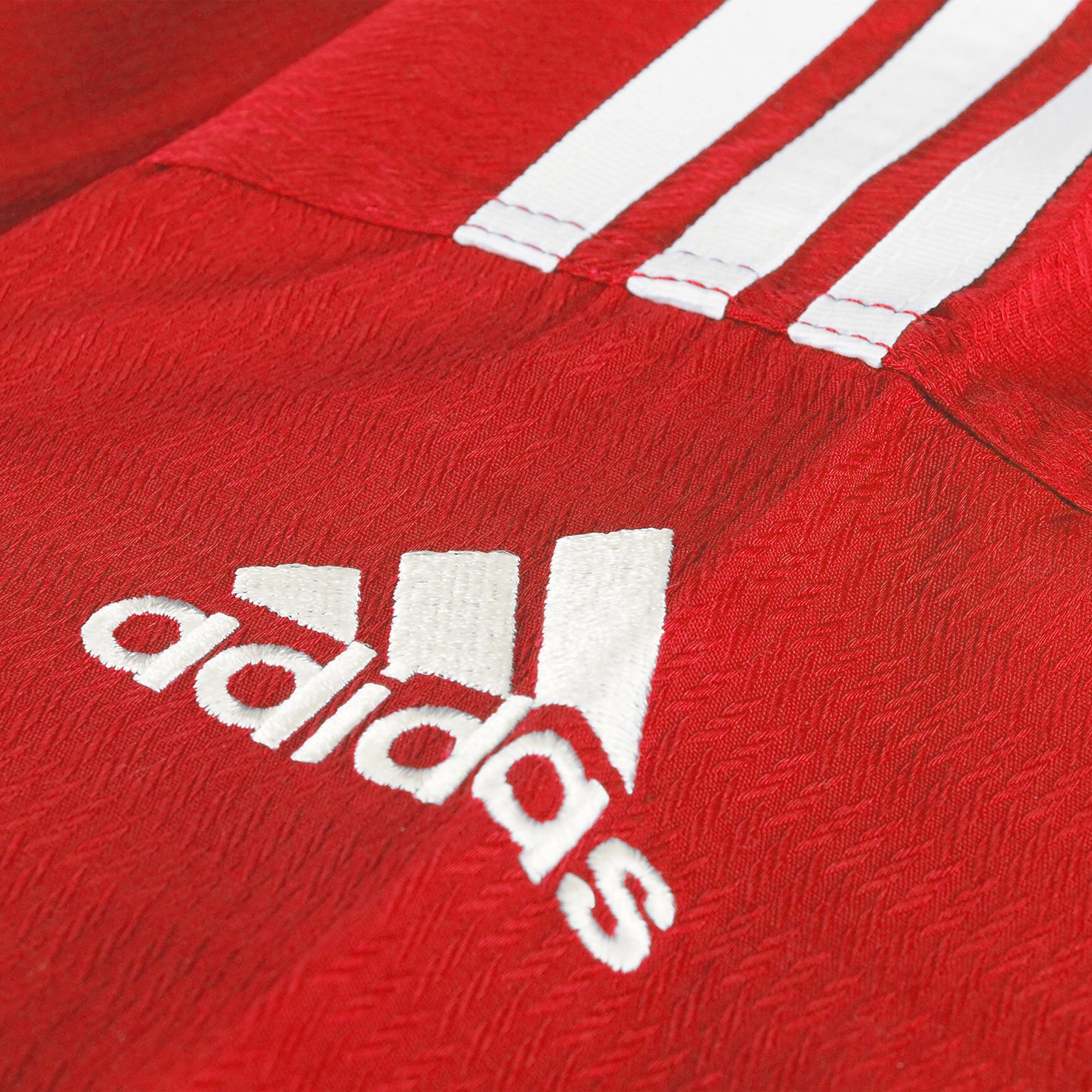 Red shirt close-up with focus on shoulder logo.