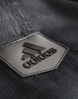 Black logo patch on black fabric from Adidas uniform.