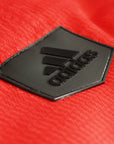 Black logo on red fabric for Adidas Champion Taekwondo uniform.