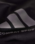 Close-up of logo on black performance shirt.