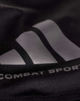 Close-up of Adidas logo on combat sports drifit T-shirt.