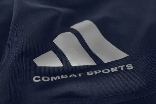 Close-up of white logo on a blue Dri-Fit t-shirt.