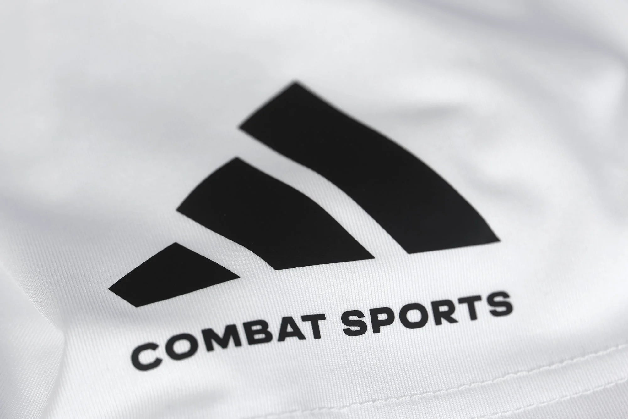 Close-up of logo on adidas Combat Sports Drifit T-shirt, Taekwondo apparel.