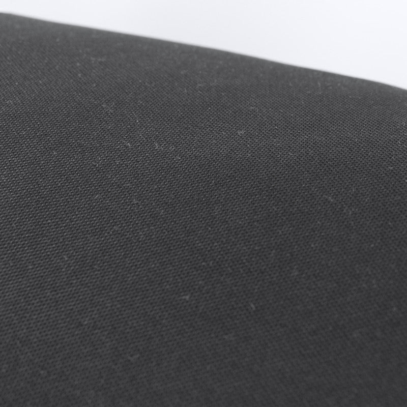 Close-up of black fabric on an Adidas boxing heavy bag.