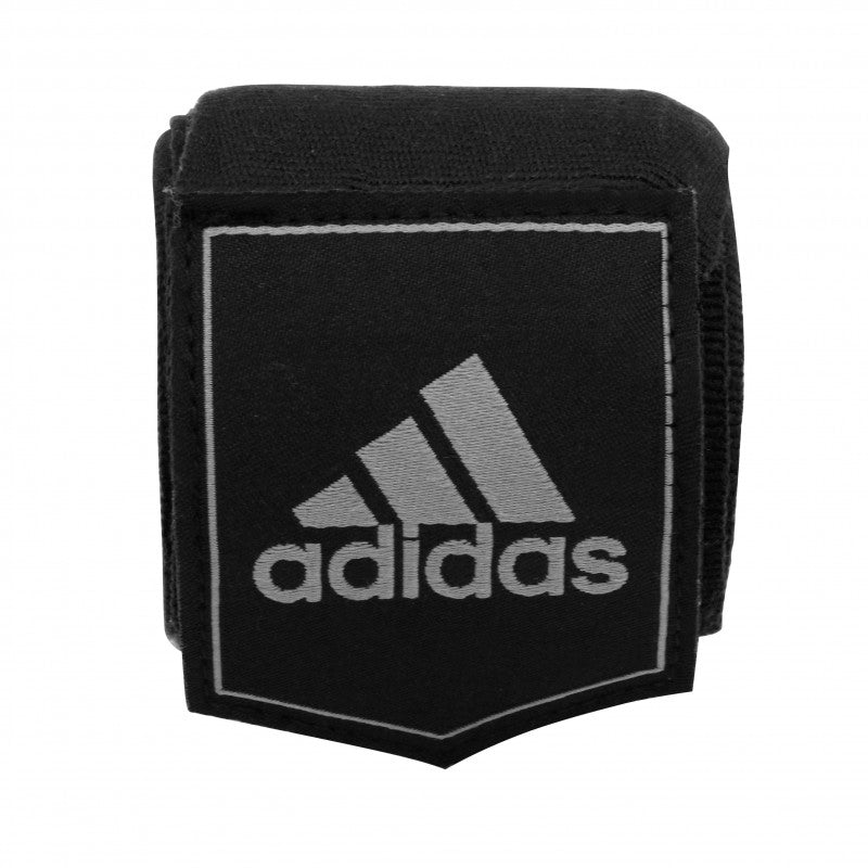 Black wrist band with white adidas logo, for boxing protection.