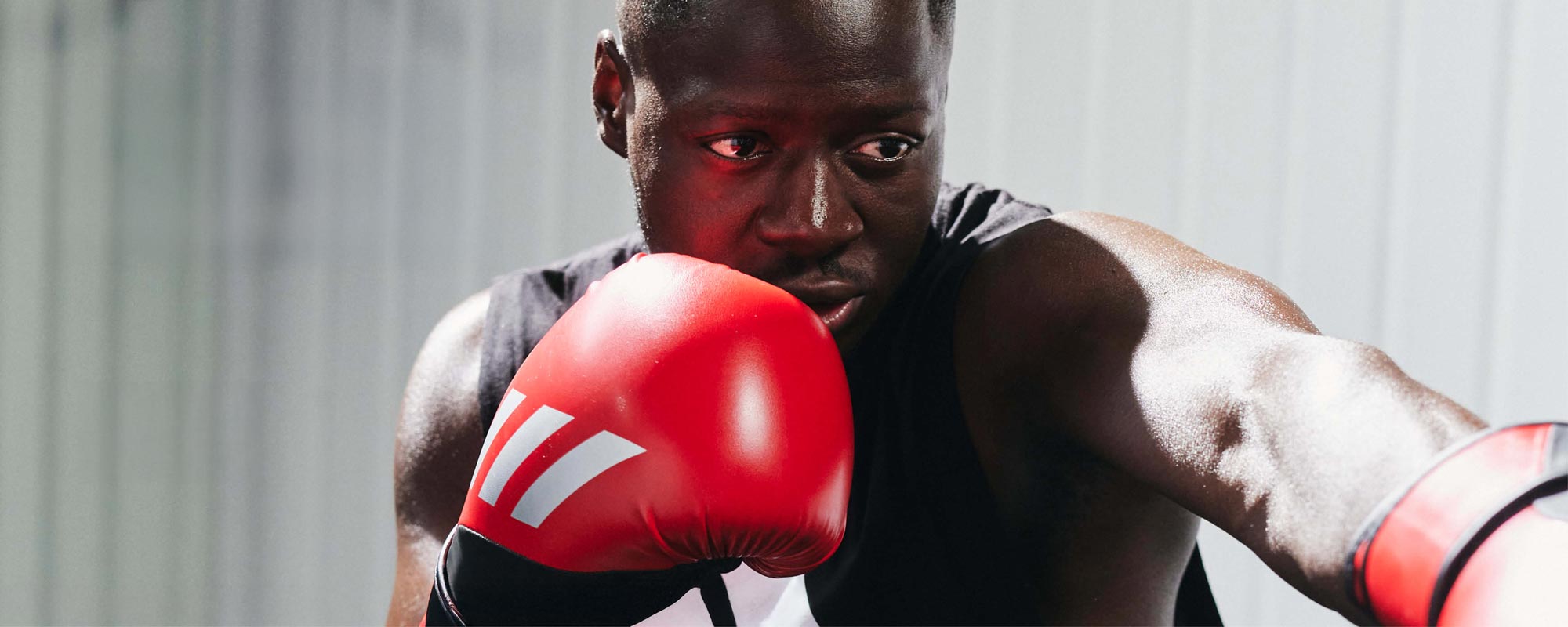 Man boxing with adidas gloves