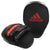 Black and red Adidas boxing mitt for training.