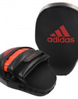 Black and red Adidas boxing mitt for training.