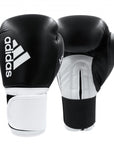 Pair of adidas Hybrid 100 women's boxing gloves in black and white.