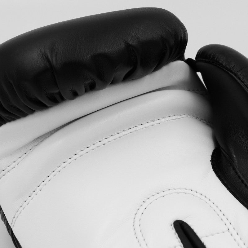 Close-up of adidas Hybrid 50 boxing glove in black and white.