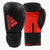 Pair of adidas Hybrid 50 boxing gloves, black and white.