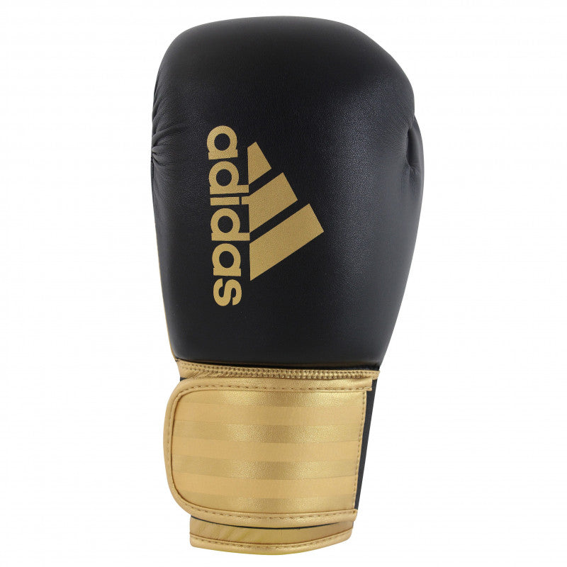 A black and gold Adidas Hybrid 100 boxing glove, 14 oz weight.