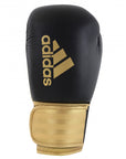 A black and gold Adidas Hybrid 100 boxing glove, 14 oz weight.