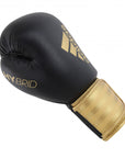 Adidas Hybrid 100 black and gold boxing glove, 10 oz, for men and women.