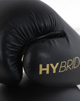 Black boxing glove with gold text, adidas Hybrid 100 model.