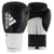 Pair of black and gold Adidas boxing gloves for training.