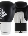 Pair of black and gold Adidas boxing gloves for training.