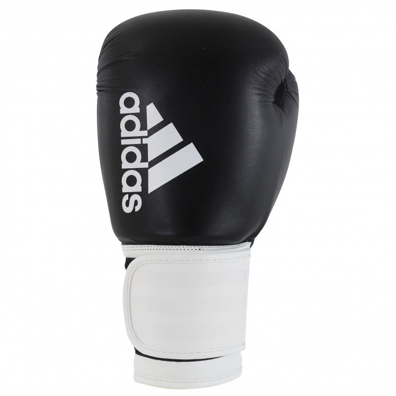 A black and white Adidas Hybrid 100 boxing glove, 14 oz weight.