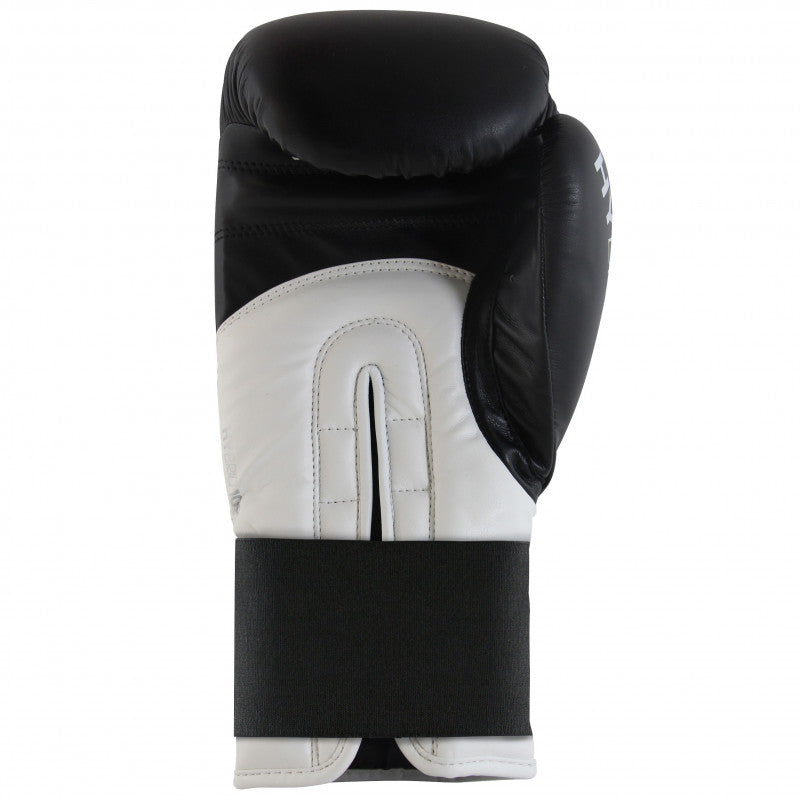 A black and white Adidas Hybrid 100 boxing glove, 10 oz weight.