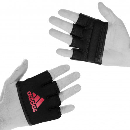 Pair of hands in black gloves for boxing knuckle protection.