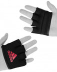 Pair of hands in black gloves for boxing knuckle protection.