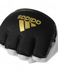 Black and white glove with gold adidas logo for boxing protection.