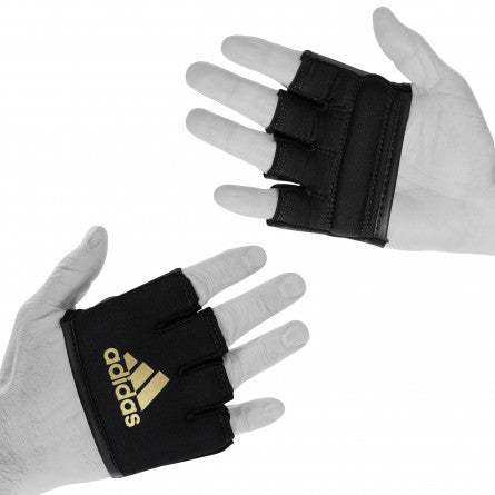 Pair of hands wearing black gloves for boxing protection.