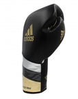 A black and gold boxing glove by adidas, 16 oz, for boxing and kickboxing.