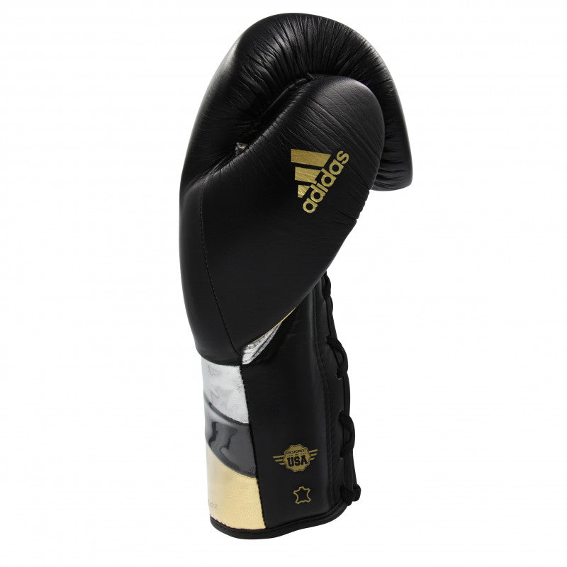 A black boxing glove with gold accents by adidas, 14 oz.