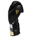 A black boxing glove with gold accents by adidas, 14 oz.