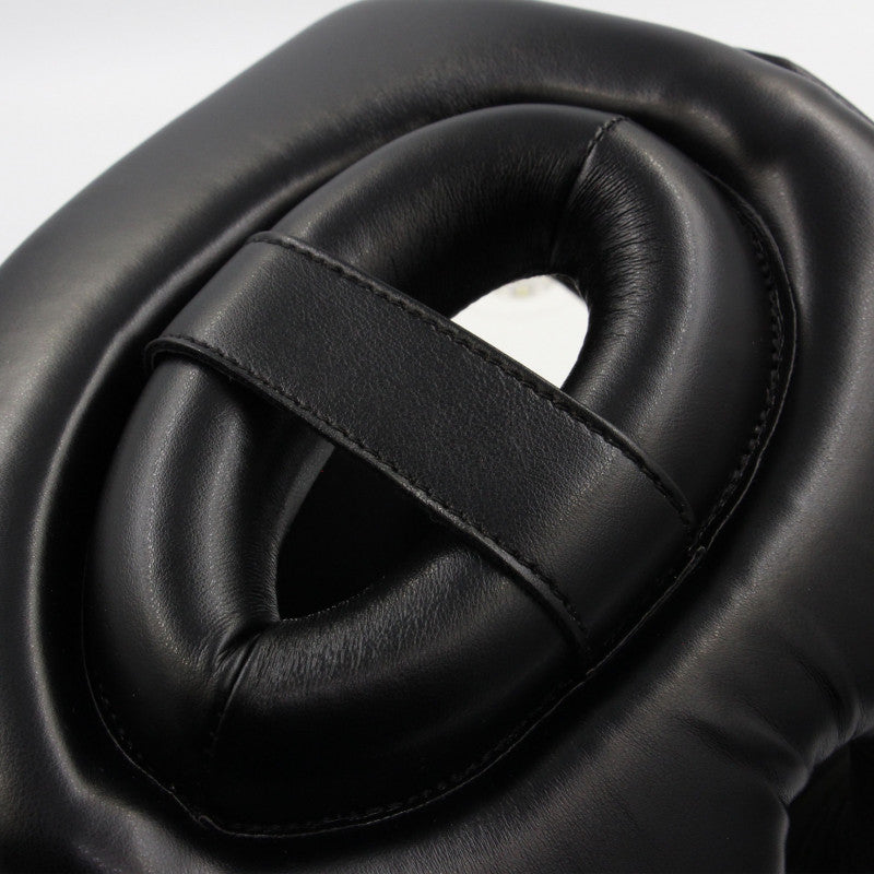 Boxing headgear with a black design featuring a central hole.