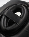 Boxing headgear with a black design featuring a central hole.