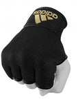 Hand with a large black glove featuring gold accents.