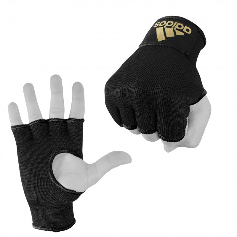 Hand wearing a black glove with gold detail.