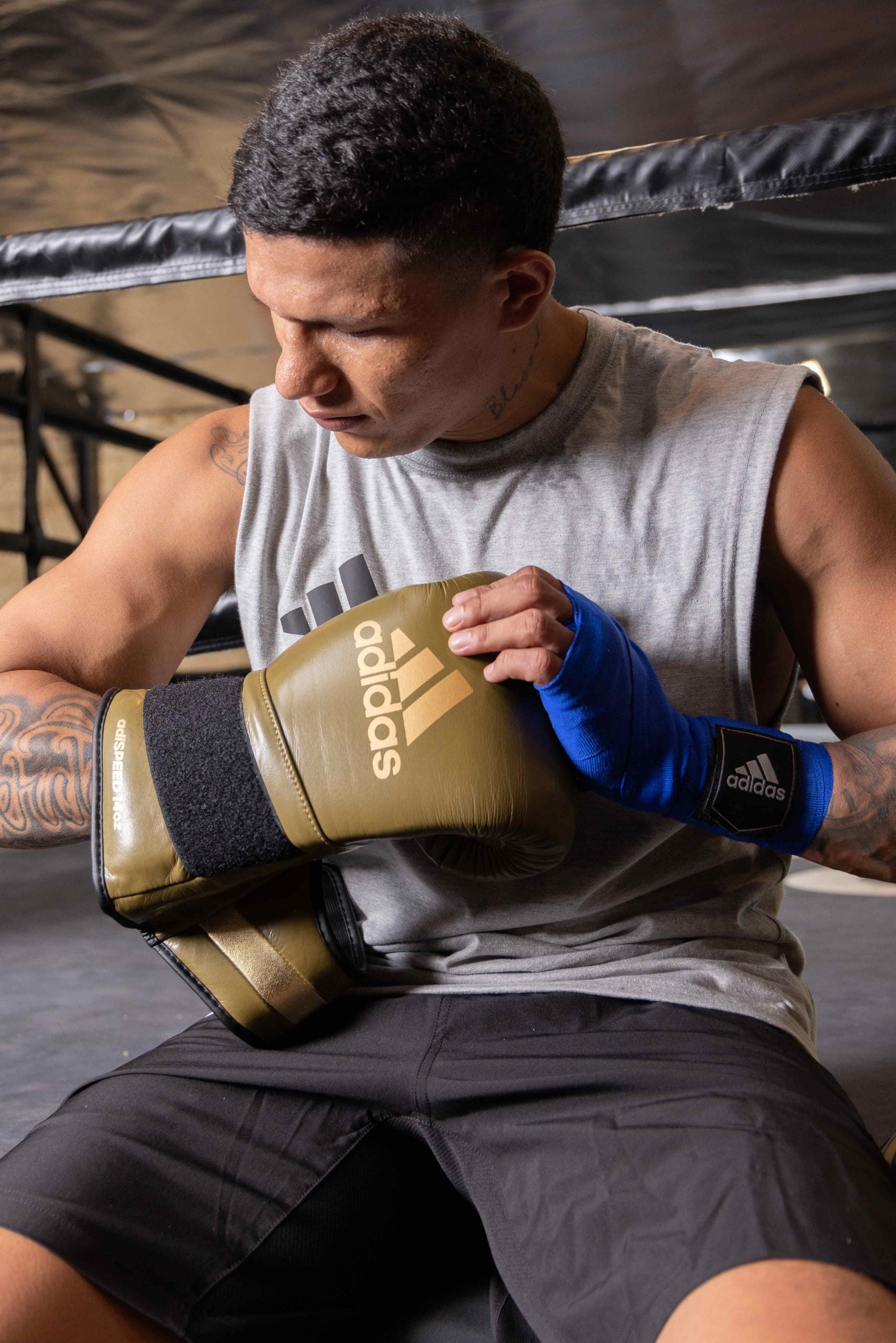 Man wearing limited edition adiSPEED 501 boxing gloves.