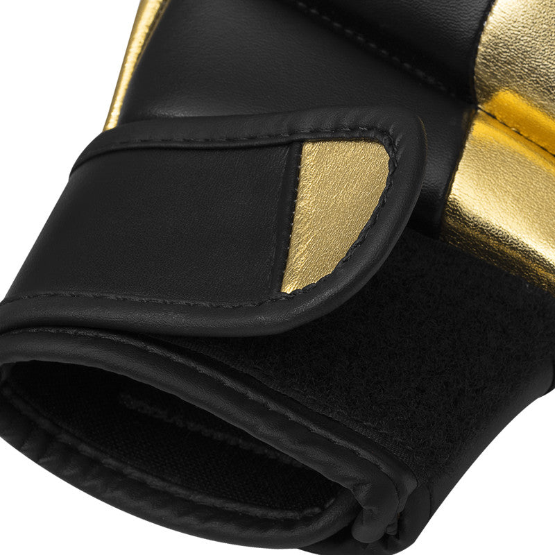 Close-up of a GRAPPLING 350 boxing glove in white and gold.