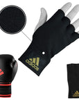 Black glove next to white and black boxing gloves on a bag.