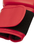 Red boxing glove with black straps, side view.