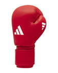 Red boxing glove with a white logo, showcasing Adidas IBA certified gloves.