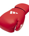 Red Adidas boxing glove with white logo.