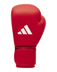 Red boxing glove with a white logo, demonstrating Adidas IBA competition gloves.