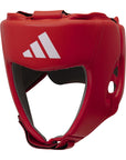 A red boxing helmet with a white logo for competitions.