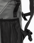 Close-up view of a grey backpack, showing texture detail.