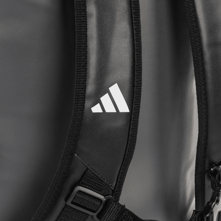 Detailed close-up of a grey backpack for sports use.