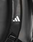 Detailed close-up of a grey backpack for sports use.