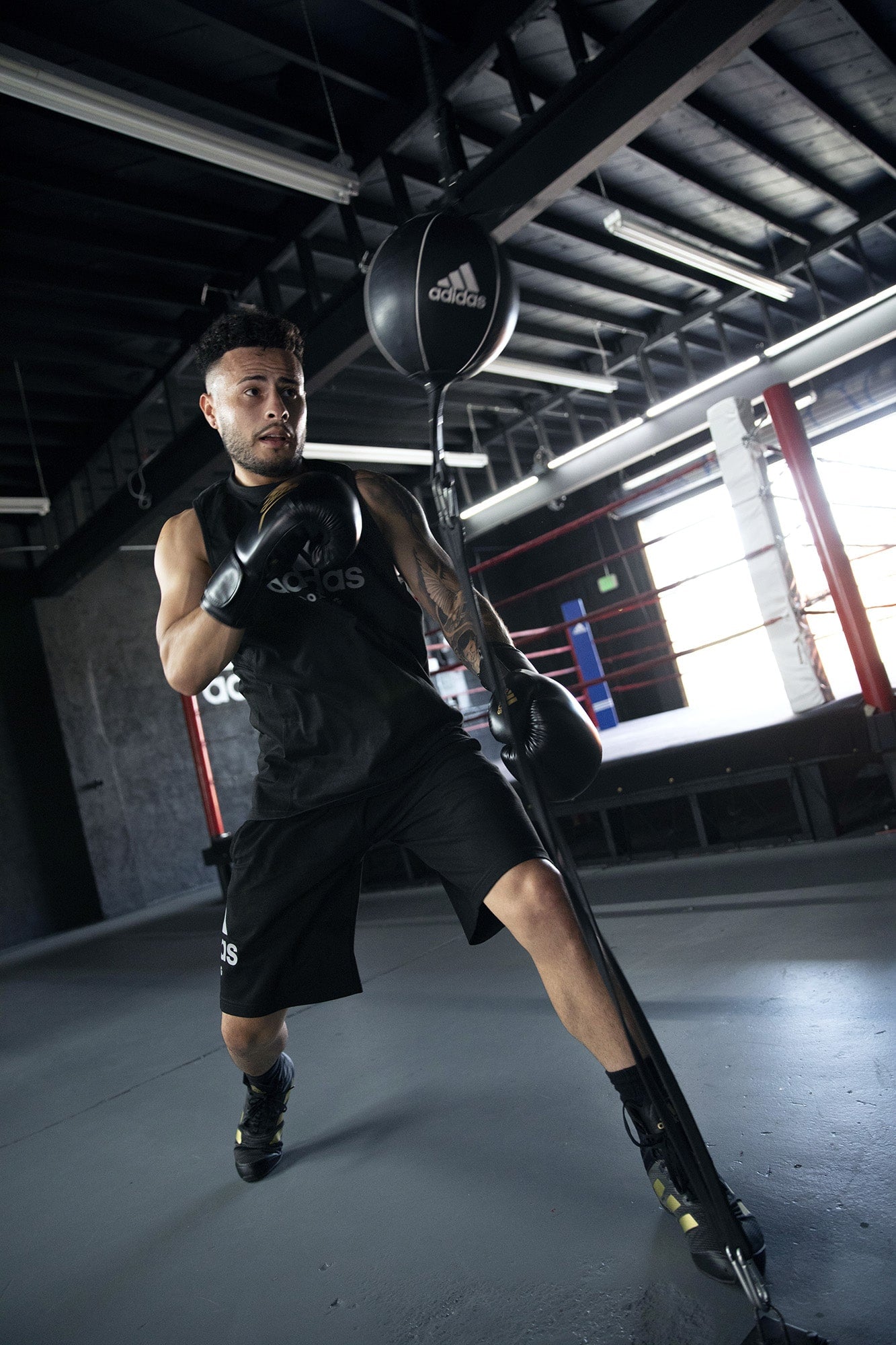 A man wearing a boxing glove holding a punching bag.