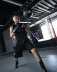 A man wearing a boxing glove holding a punching bag.